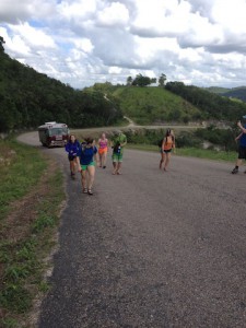 The group walking up the hill towards the Mennonite store. Our bus is tagging along behind. Photo by Savannah Judge.