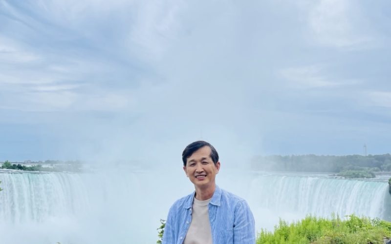 Young Woo Lee standing at Niagara falls